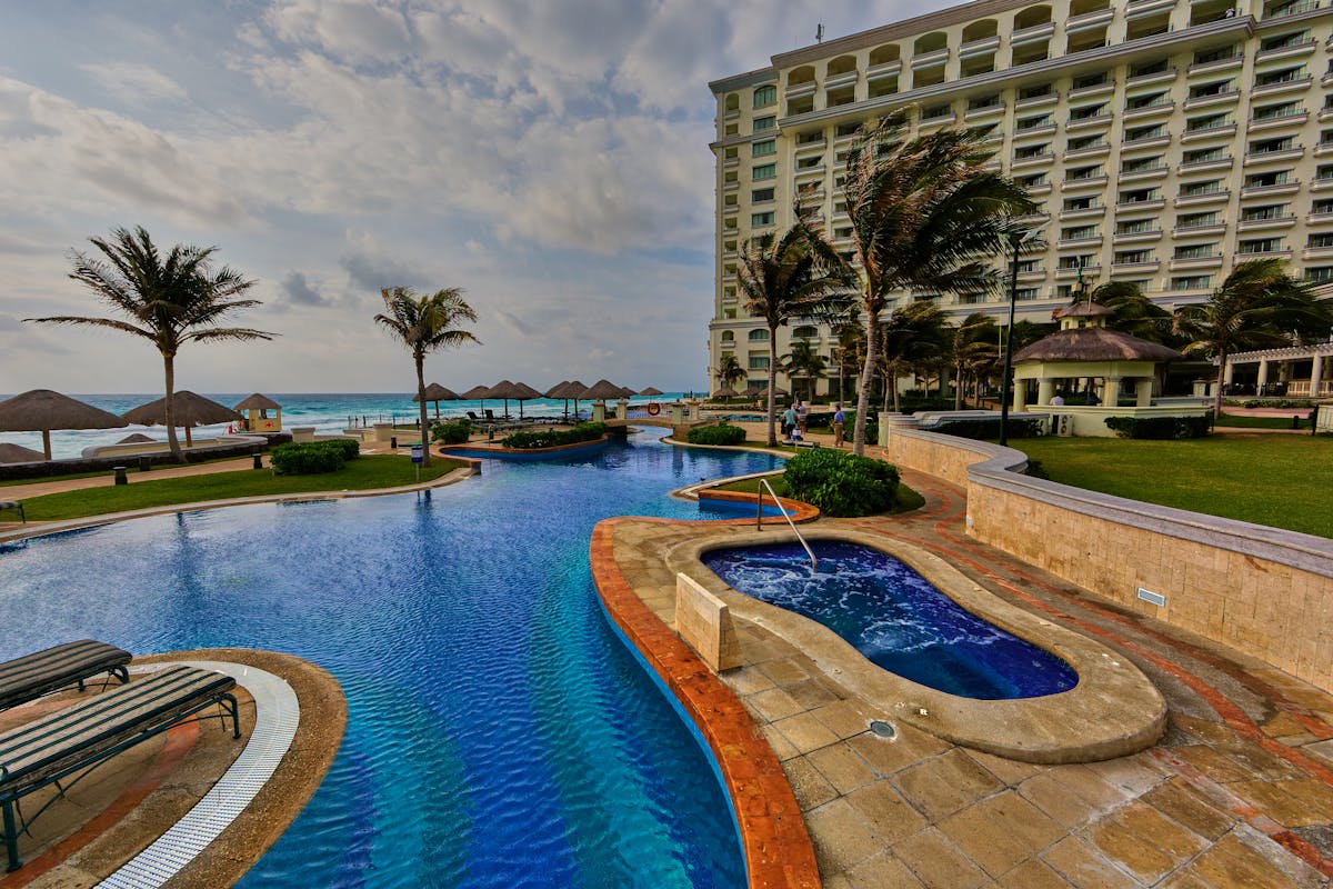 Luxury family resort in Cancun Mexico with infinity pool overlooking Caribbean ocean