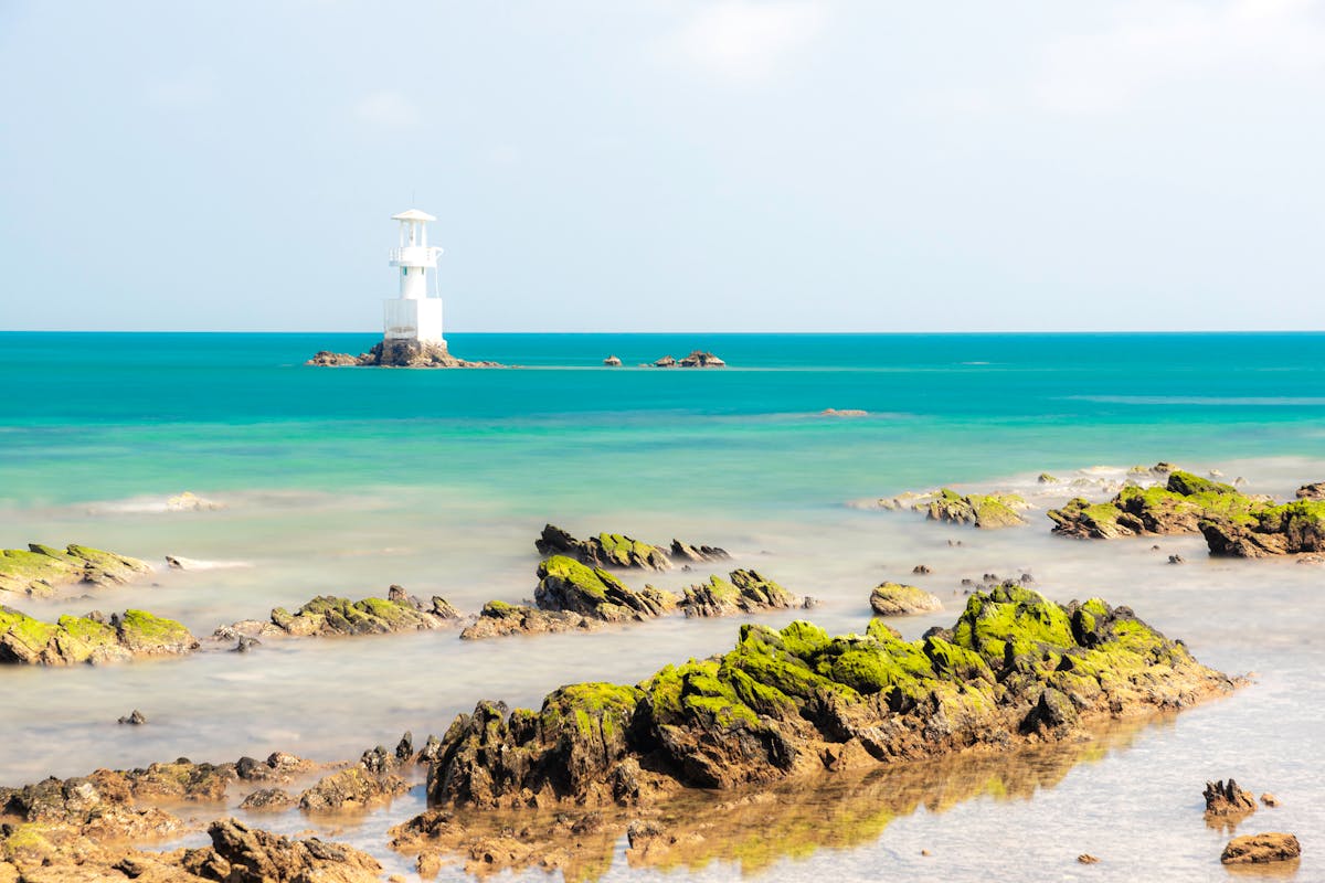 Coastal lighthouse overlooking the ocean on a clear day