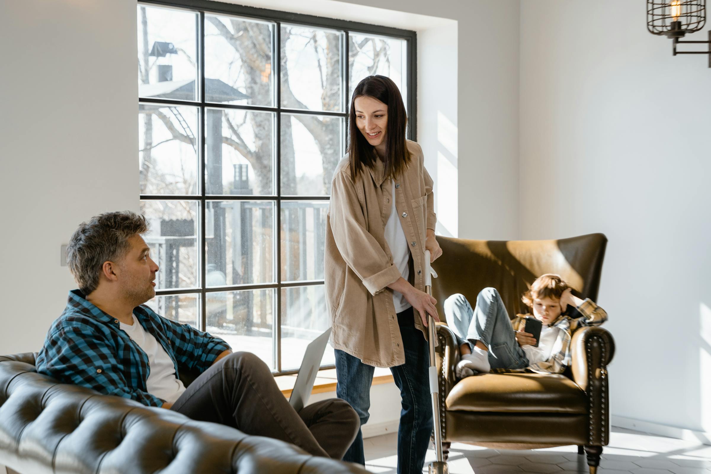 Family relaxing in a vacation rental living room during a long family holiday