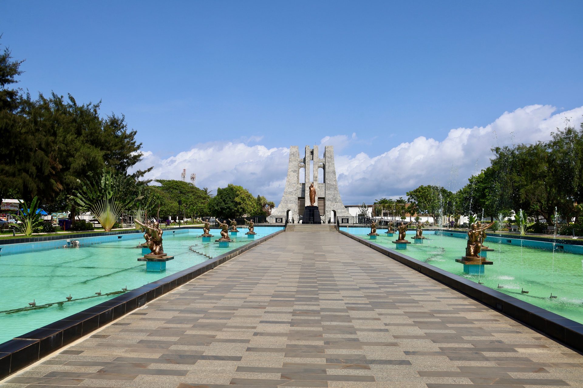 Kwame Nkrumah Memorial Park in Accra, Ghana, with bronze statues in fountain pools leading to the mausoleum