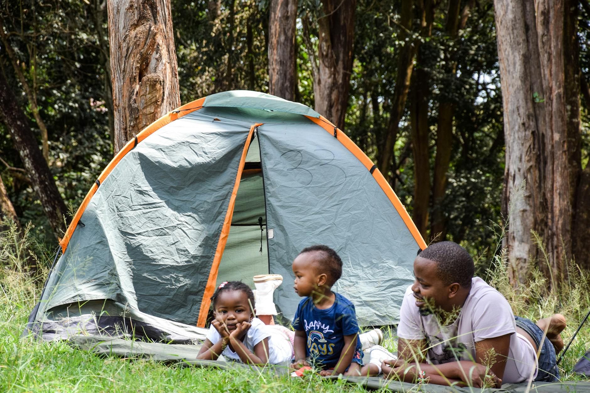 Family camping outdoors with kids on a budget-friendly vacation