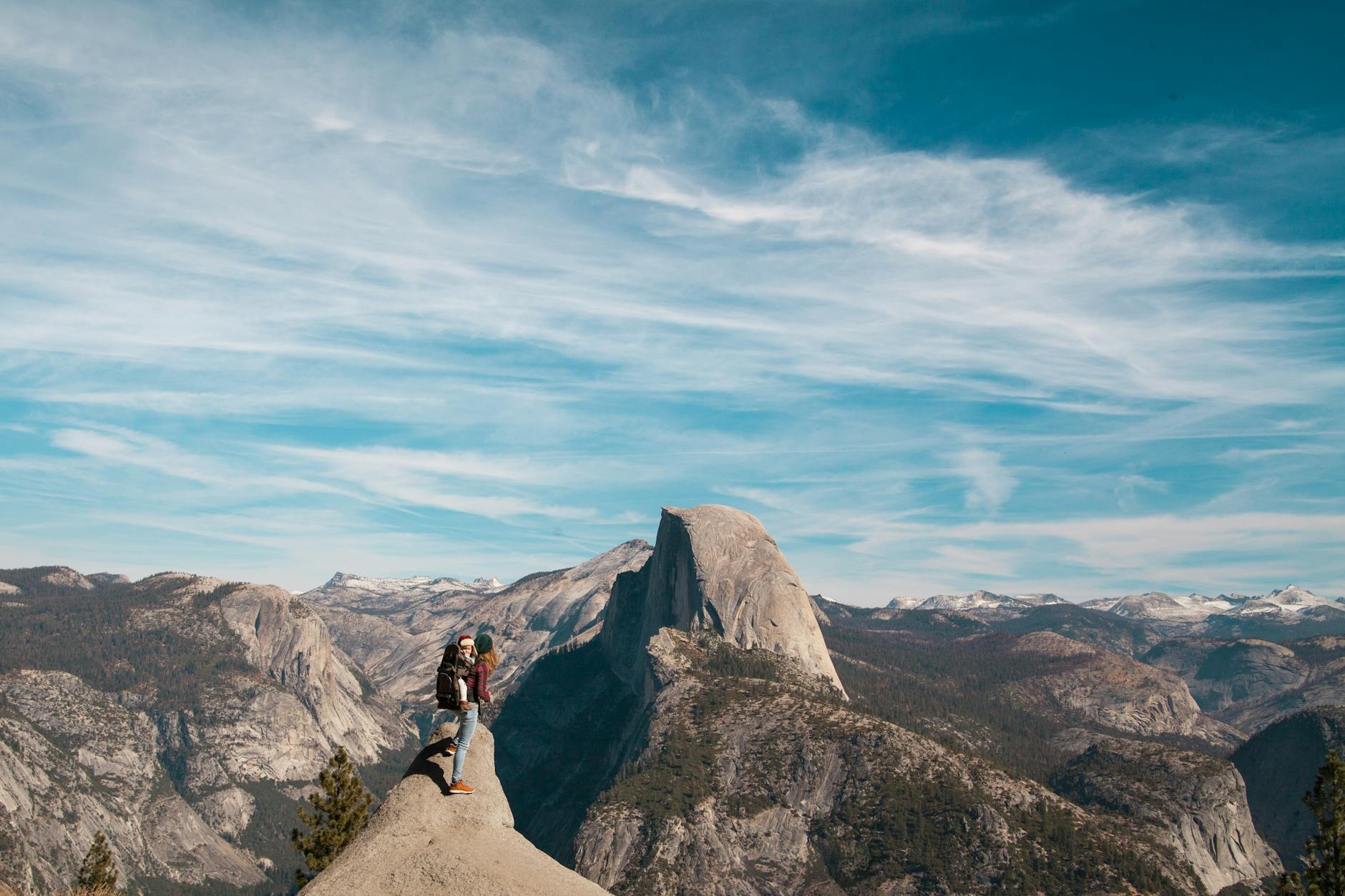 Family hiking together on a national park trail with mountain views