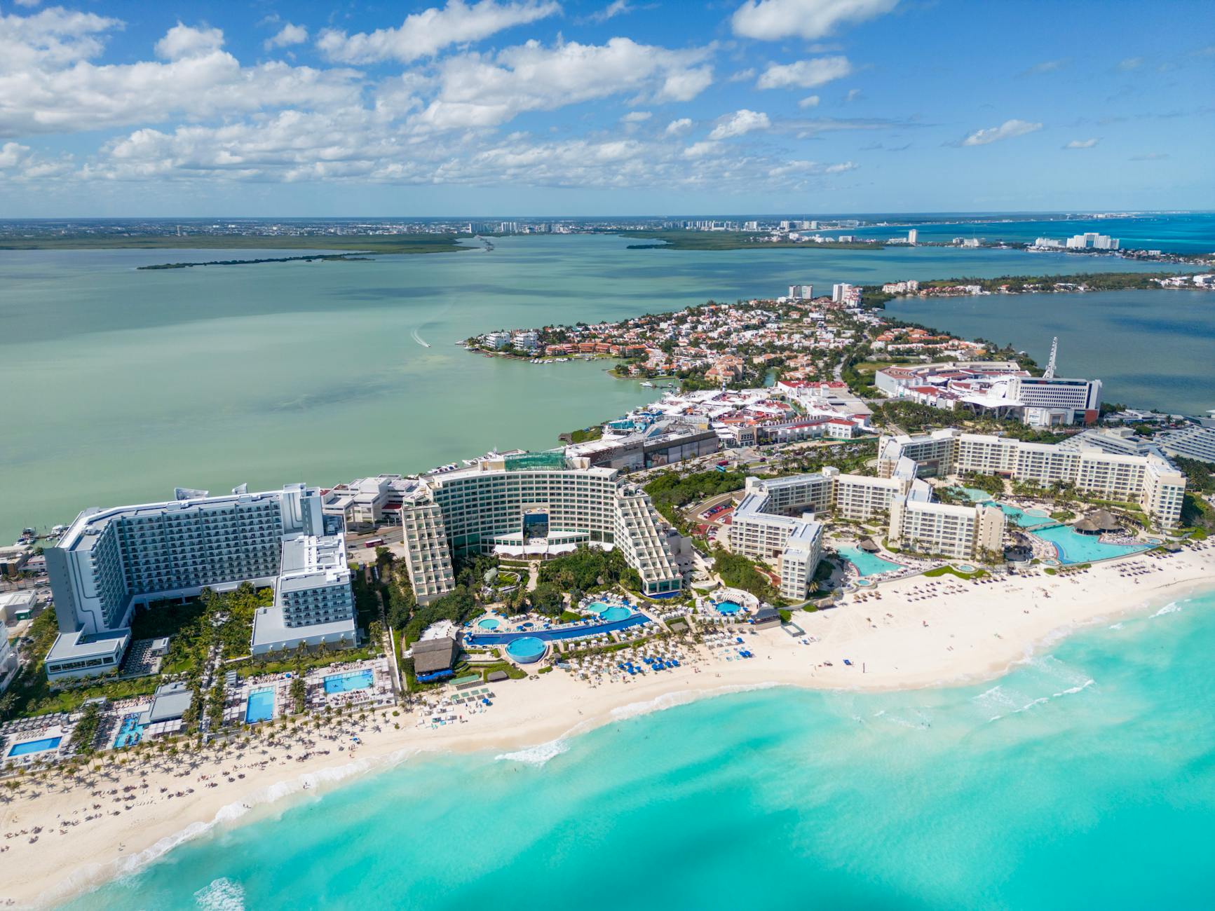 Aerial view of a Mexican Caribbean coastline with sandy beaches, turquoise water, and beachfront resorts