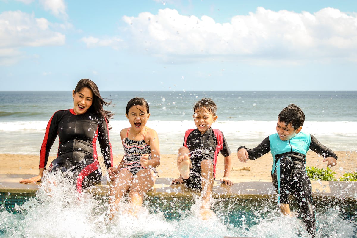 Family enjoying a sunny beach day together near the ocean