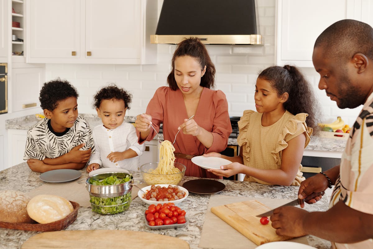 Family cooking together in a bright vacation rental kitchen