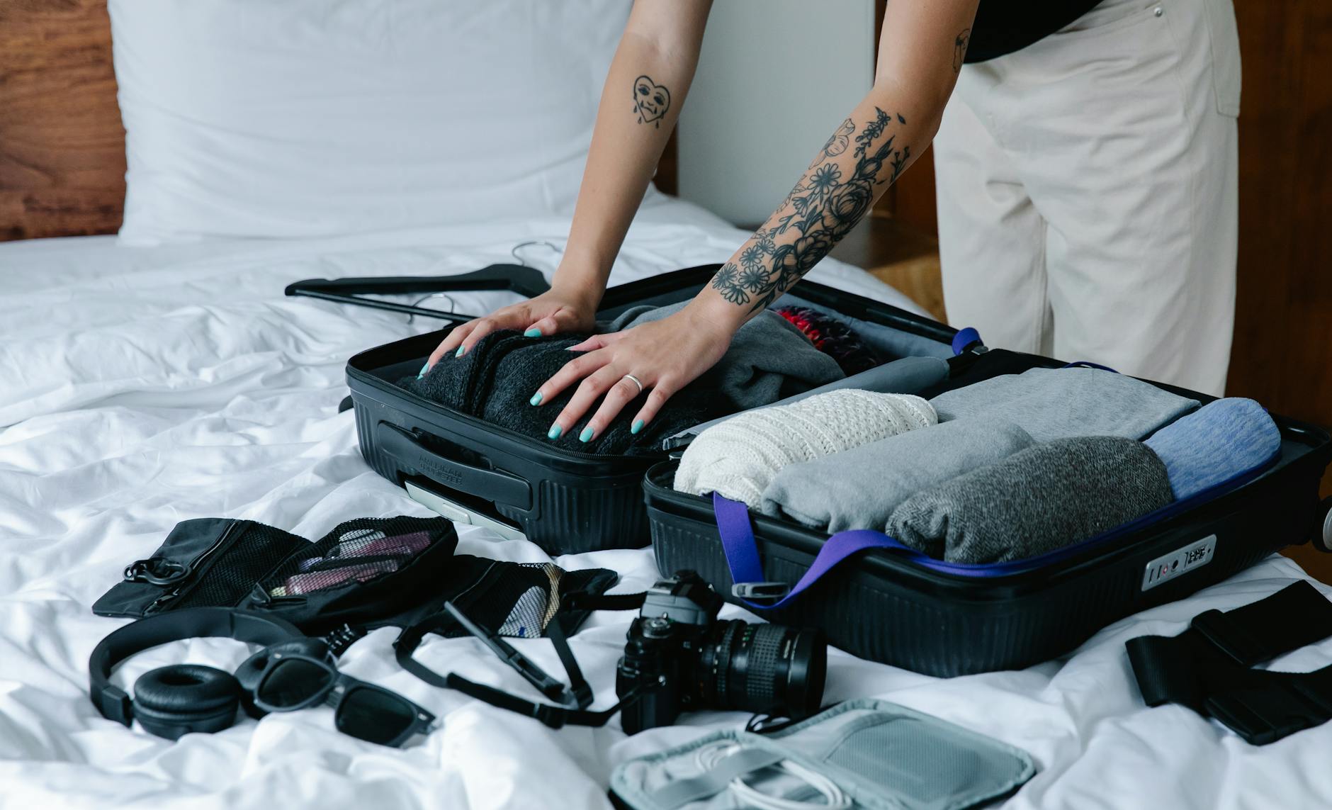 Woman packing suitcase on bed preparing for family vacation trip