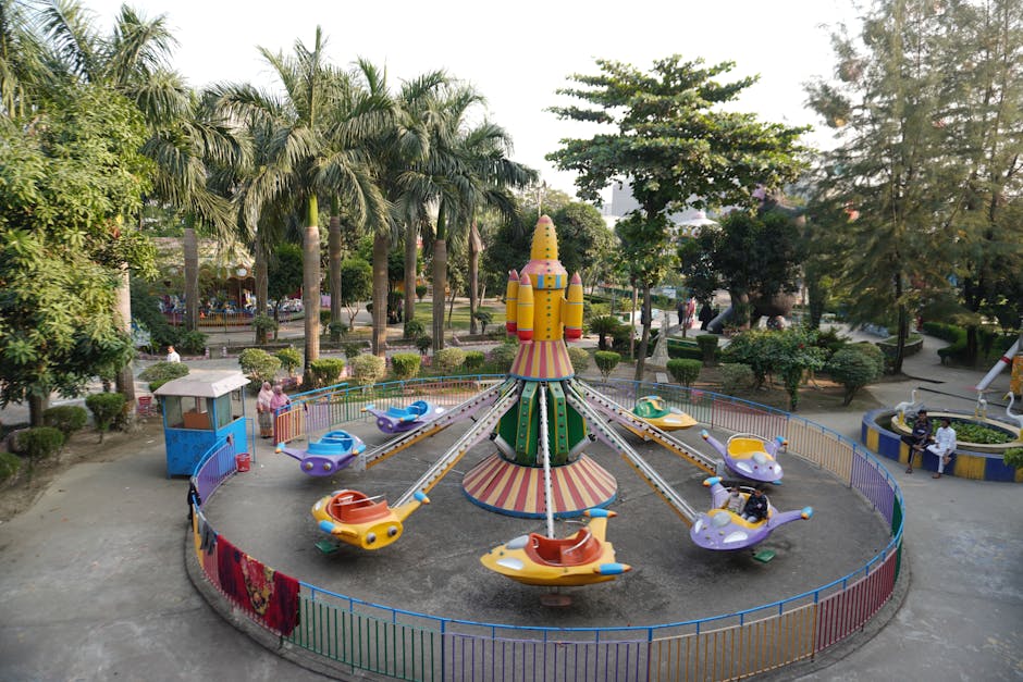 Colorful children's ride at a sunny amusement park for families