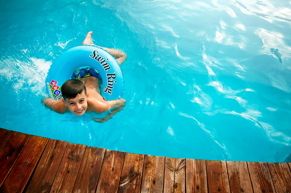Happy child enjoying swimming pool activities during family vacation