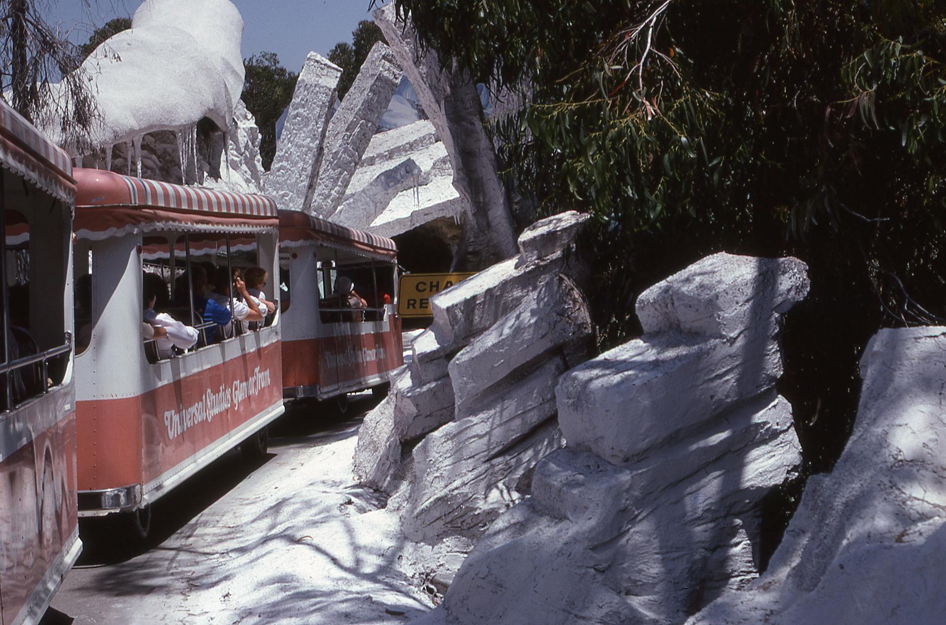 Families enjoying rides at a colorful theme park