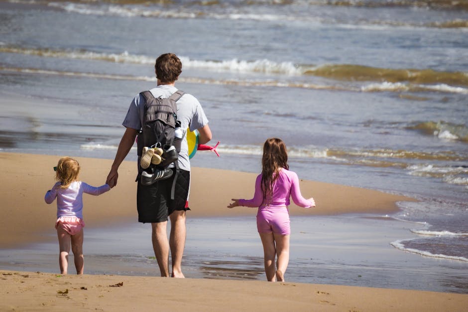 Father and children walking together on a budget-friendly beach vacation