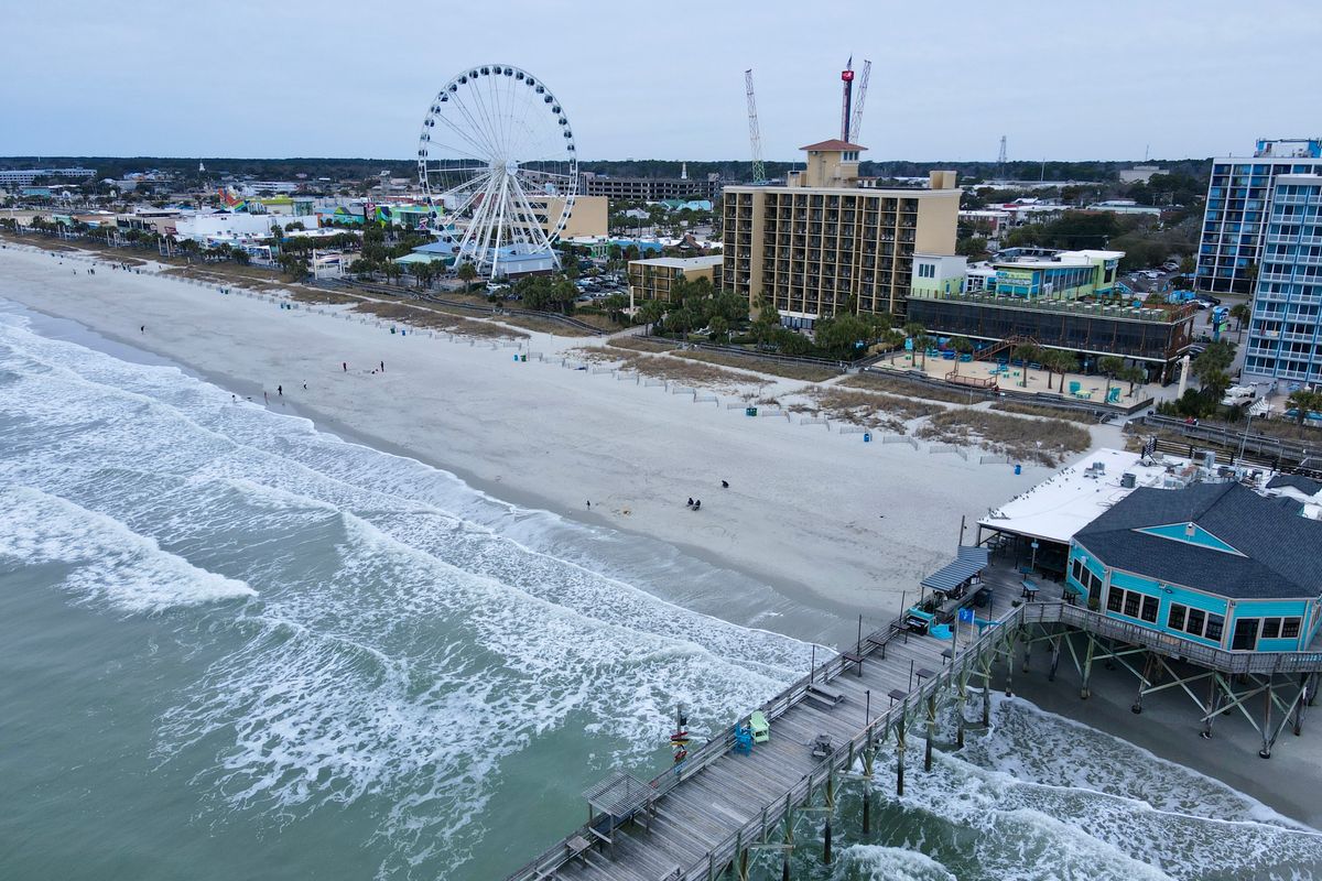 Aerial view of the Myrtle Beach pier and SkyWheel near the boardwalk hotels