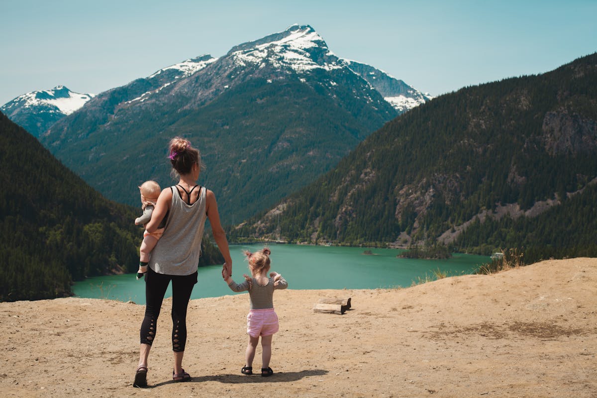 Family walking together near a lake in a natural setting