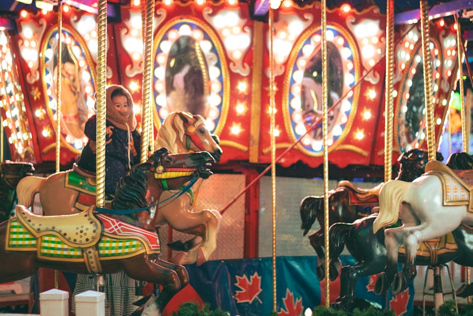 Child enjoying a brightly lit carousel ride at a family-friendly theme park