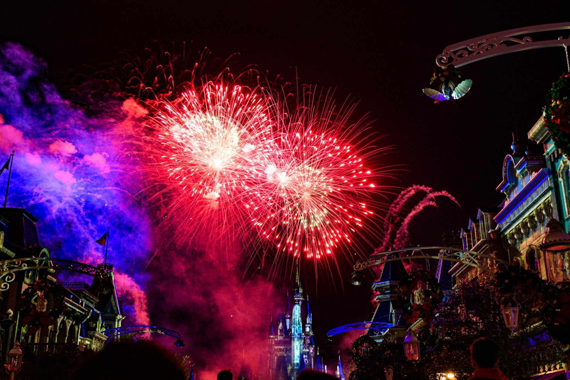 Fireworks display illuminating the night sky over Disney World castle