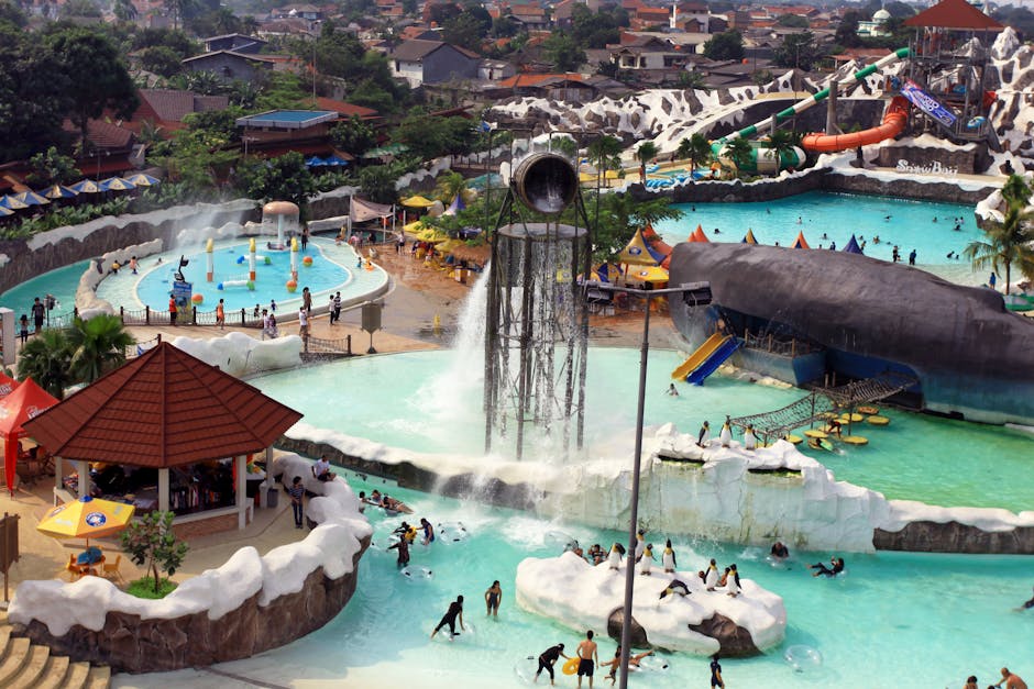 Aerial view of a water park with pools, slides, and lazy river on a sunny day
