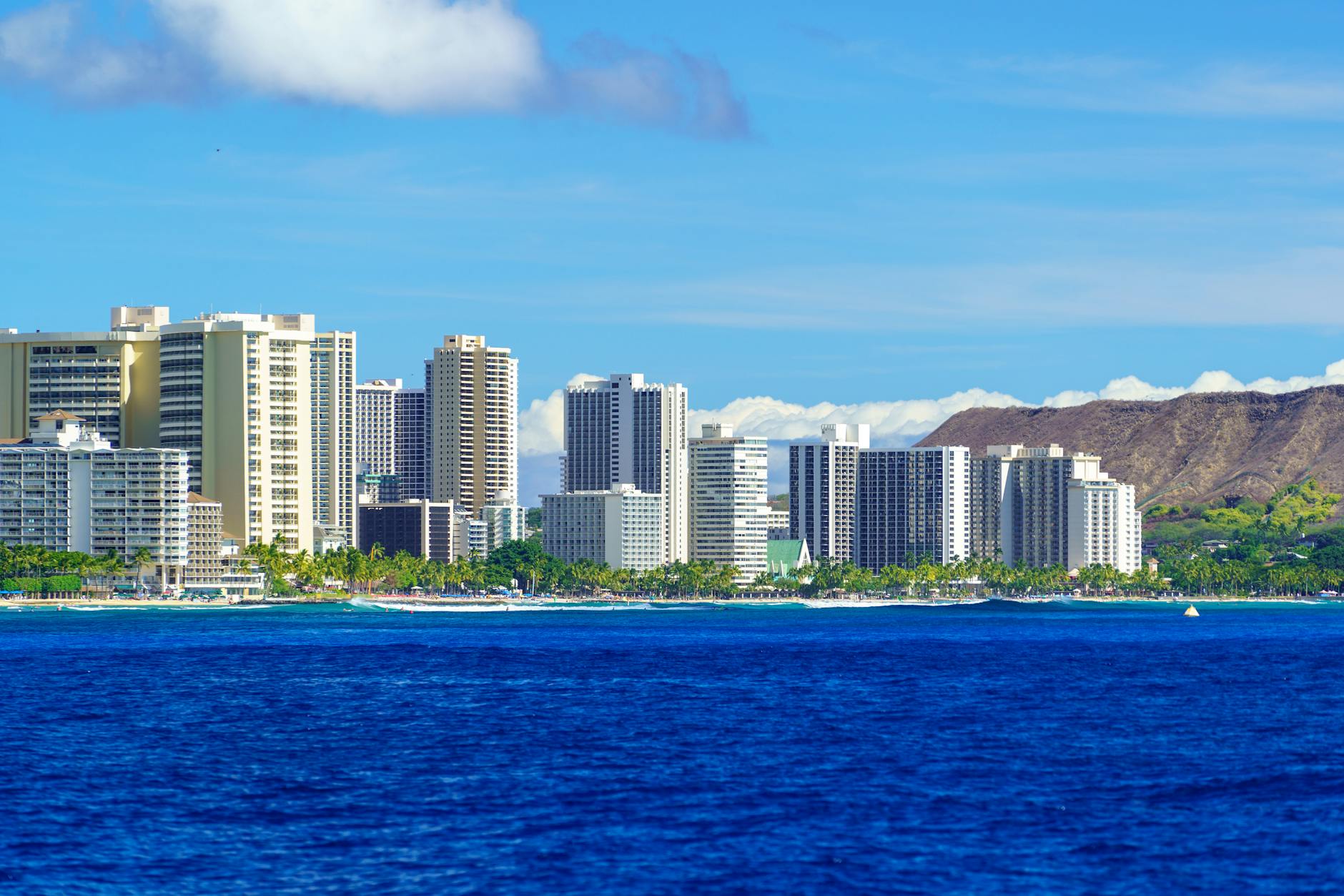 Honolulu skyline with Diamond Head crater behind Waikiki Beach on Oahu, the urban-beach combo for Hawaii family trips