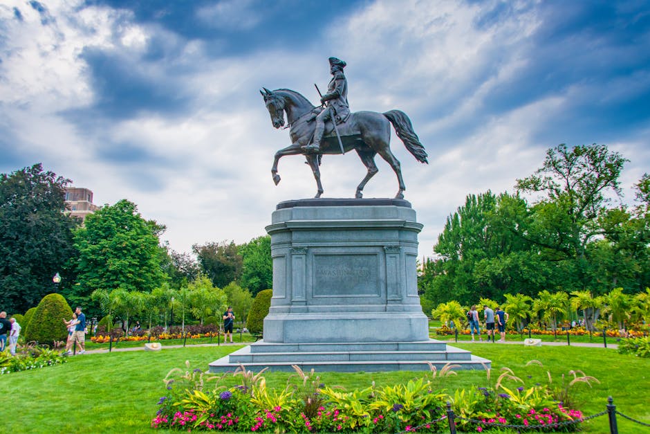 George Washington statue on horseback in Boston Public Garden surrounded by green trees