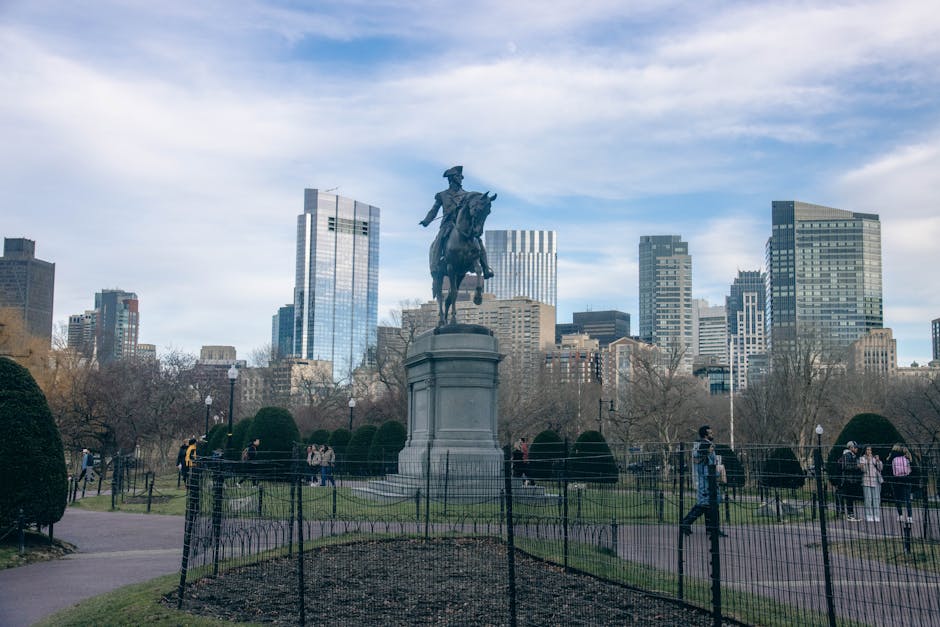 George Washington statue in Boston Public Garden with city skyline behind