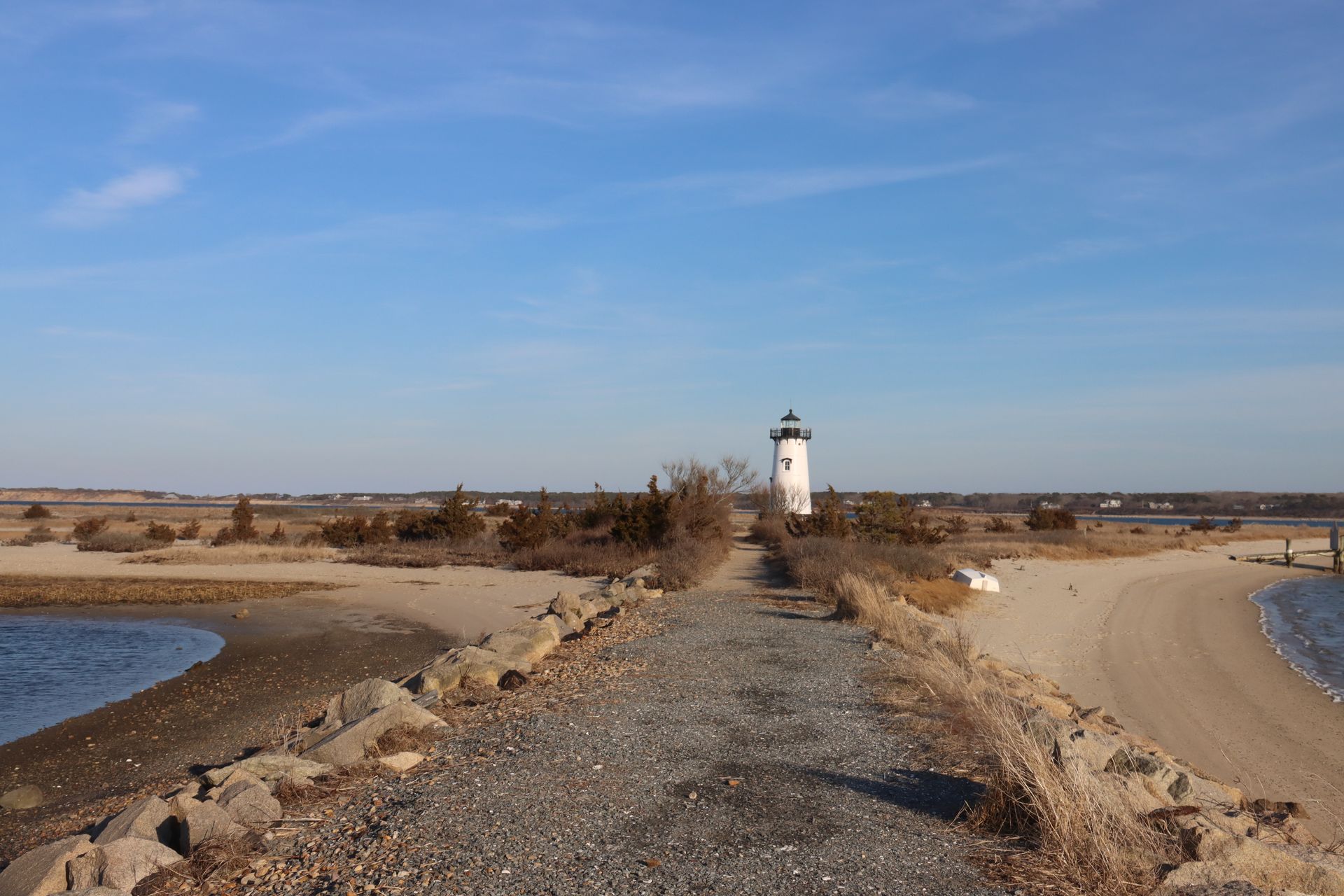 Edgartown Lighthouse on Martha's Vineyard above a sandy beach and tidal inlet