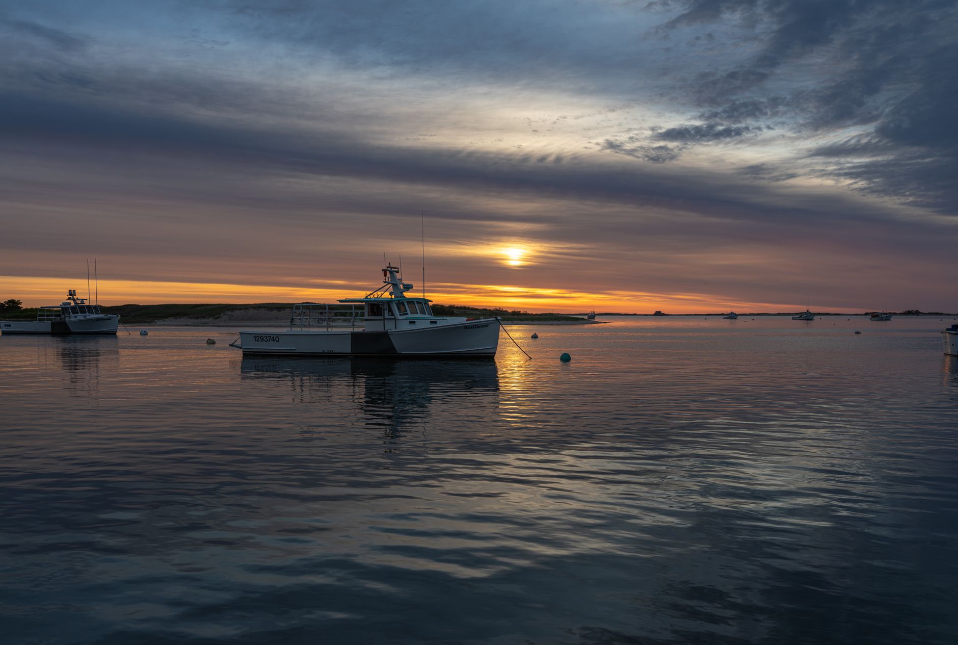 Fishing boats at sunrise in Chatham Harbor, Massachusetts &mdash; the classic Cape Cod harbor town families wander between beach days