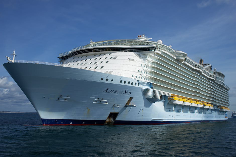 Cruise ship sailing on the open ocean under clear blue skies