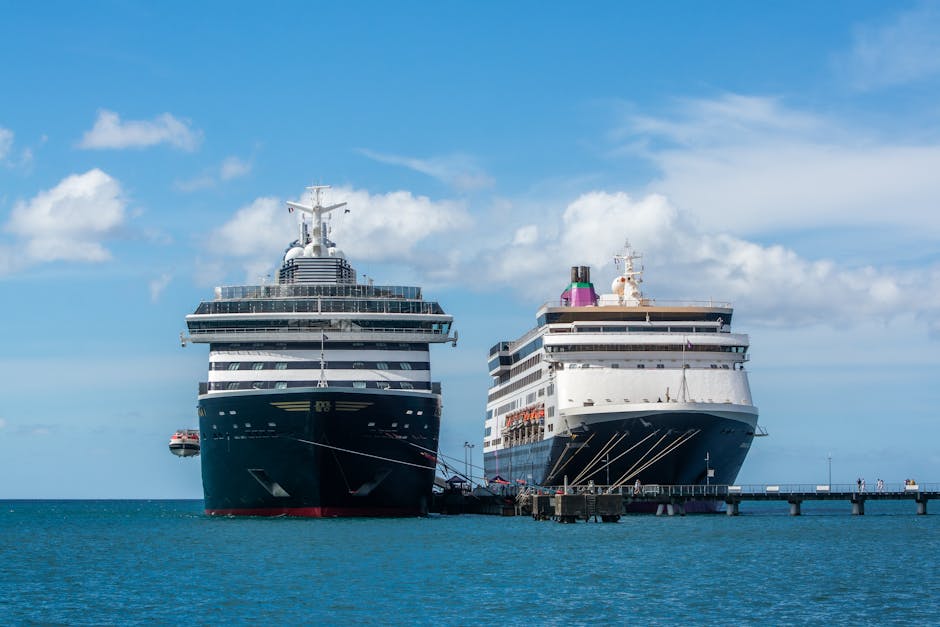 Two large cruise ships docked side by side at a sunny harbor