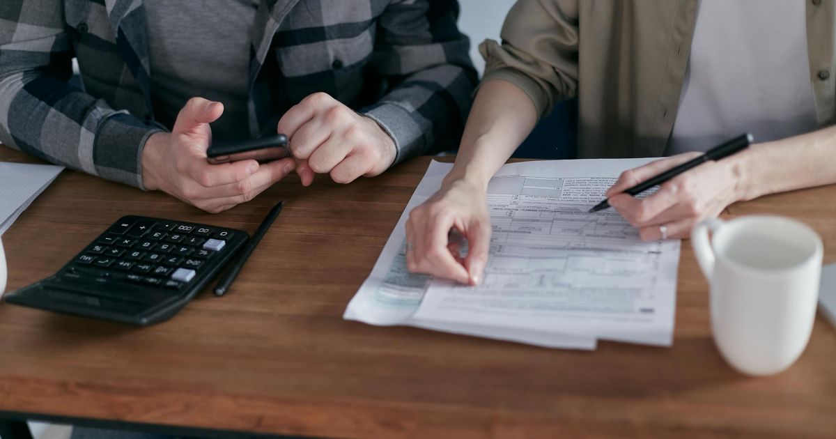 Couple reviewing finances and budgeting for Chicago family vacation