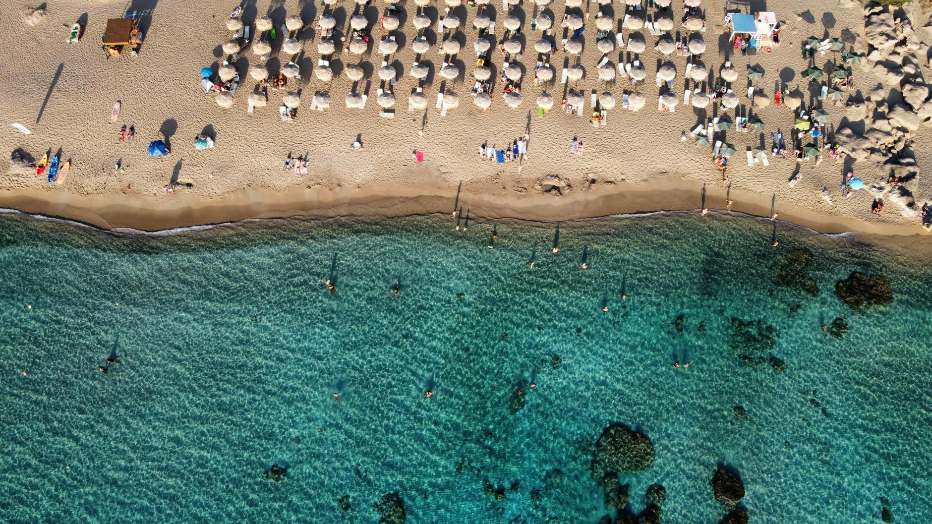 Chania beach with umbrellas from above, a Crete family holiday north-coast scene