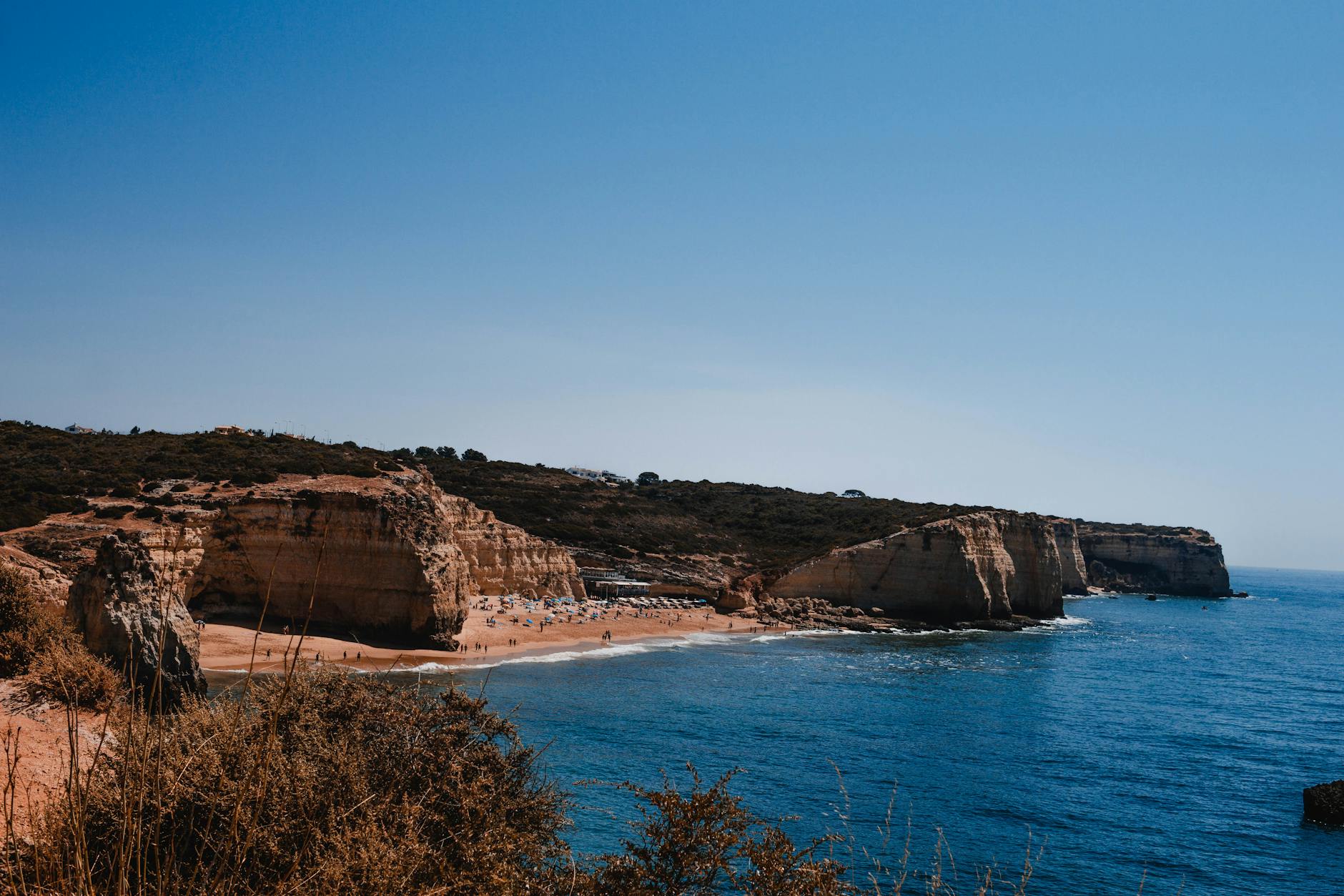 Stunning cliff beach with turquoise water on a Greek island coastline