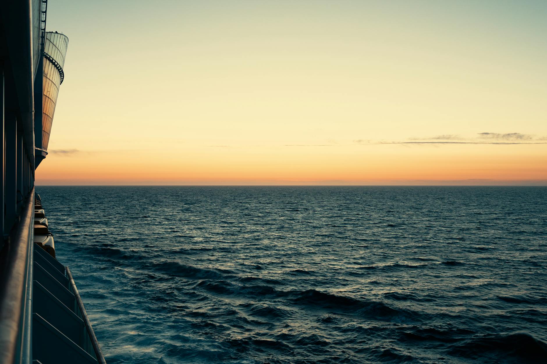 Serene ocean view from a cruise ship deck at sunset