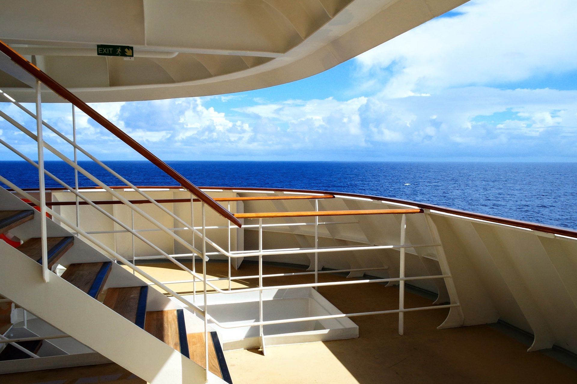 Cruise ship deck railing with the open sea beyond on a sunny morning