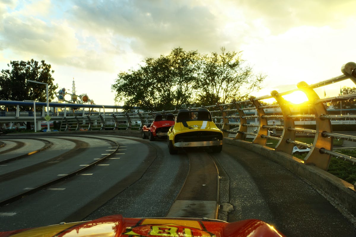 Exciting theme park ride at sunset with families enjoying the attractions
