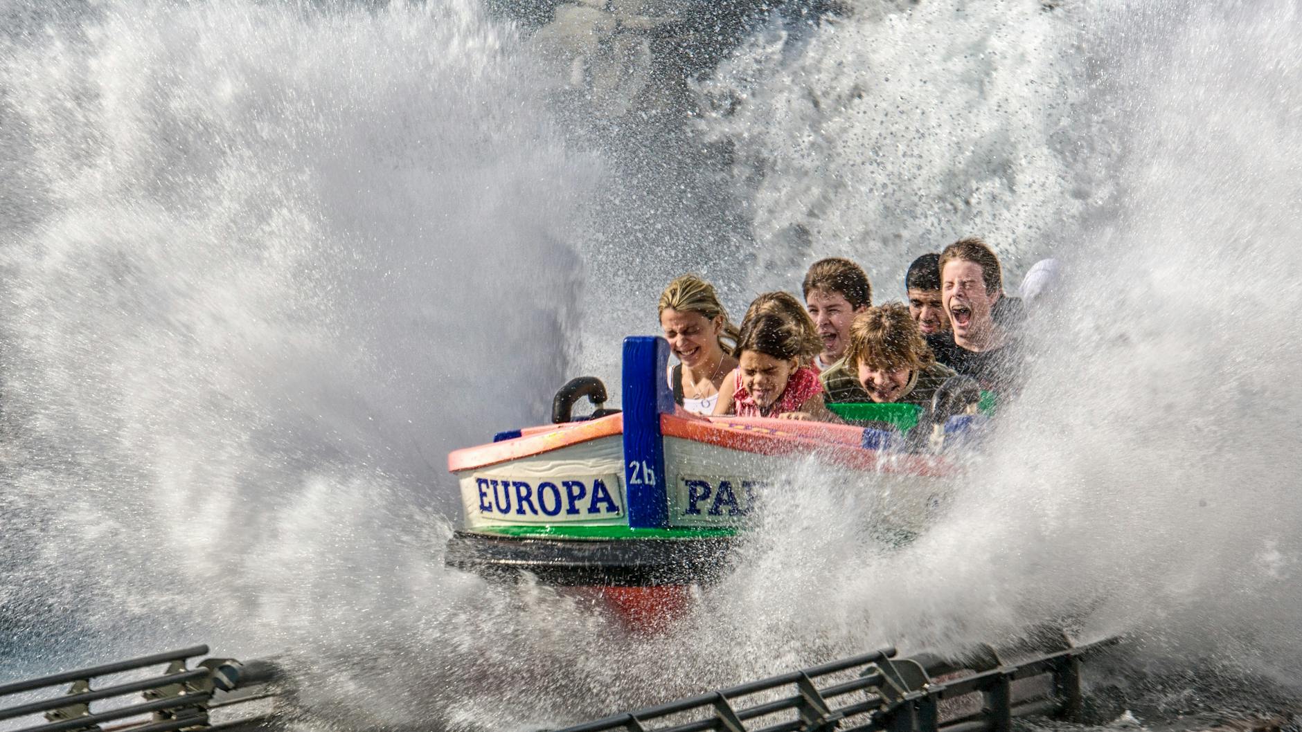 Family enjoying a water ride splash at a theme park during a Disneyland vacation