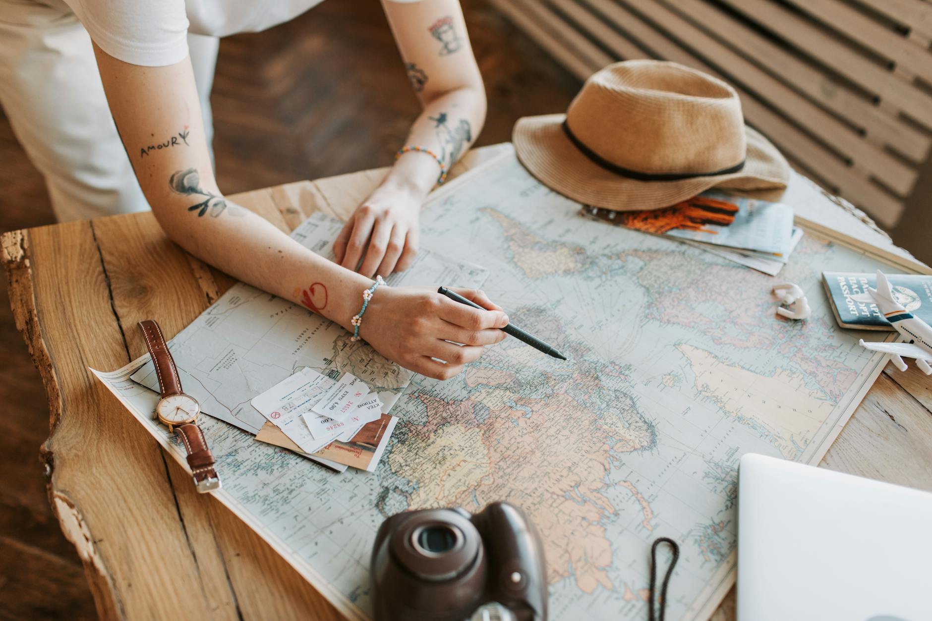 Woman planning travel with world map, passports, and travel documents