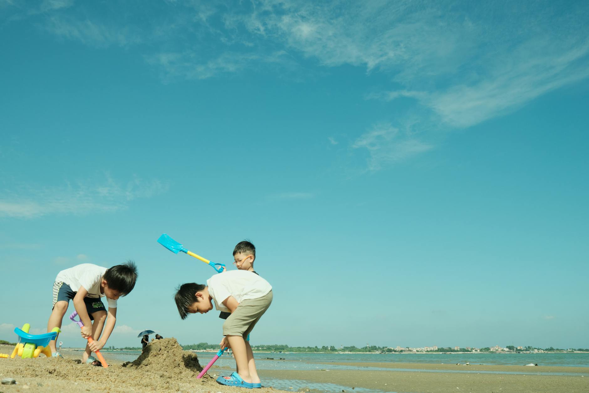 Children building sandcastles at a family-friendly beach destination