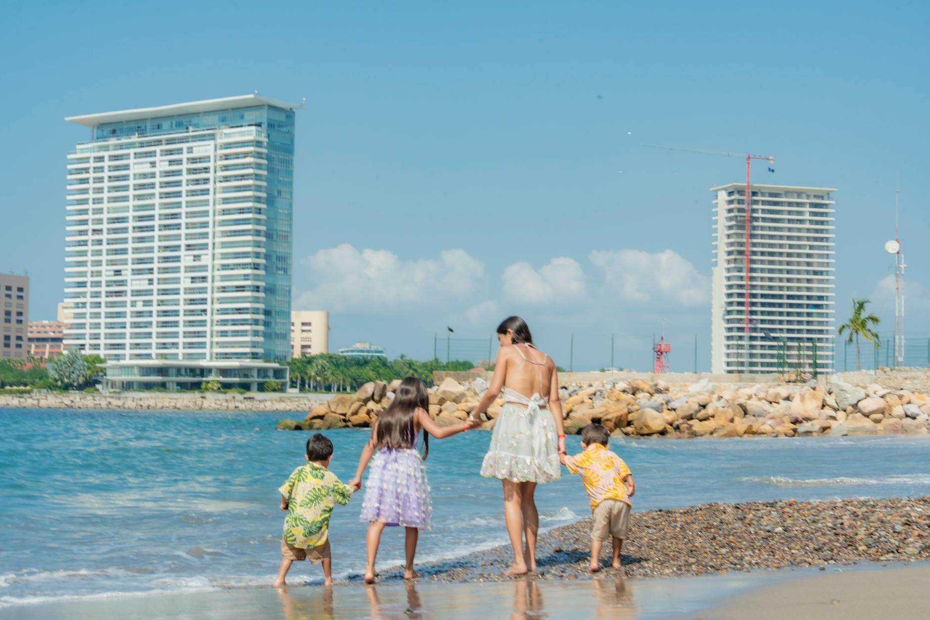 Family with children enjoying a sunny day together at the beach