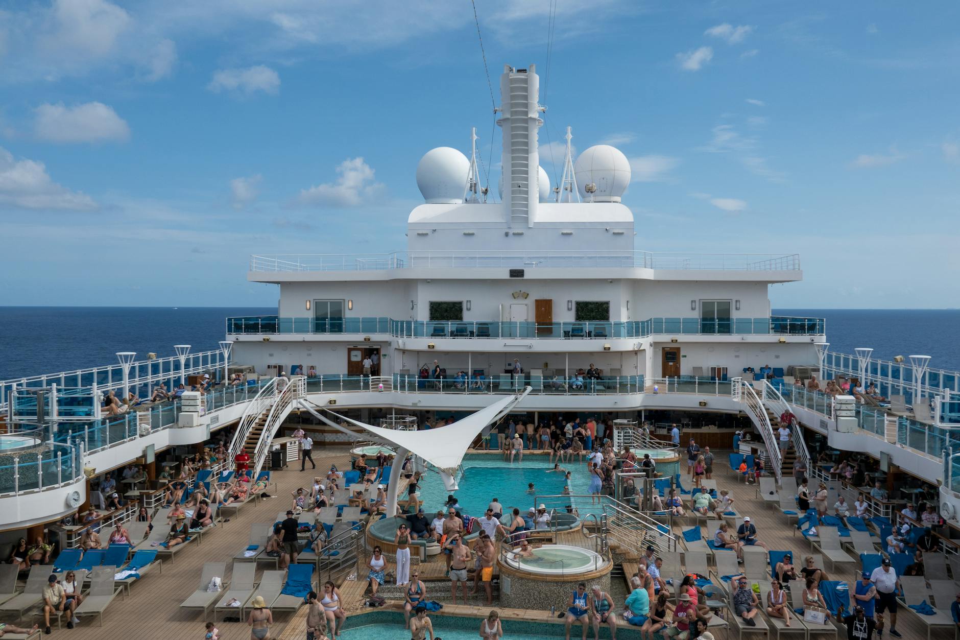 Vibrant cruise ship deck with pool and passengers &mdash; the cruise/AI gold-standard skip-gen aesthetic the top picks deliver