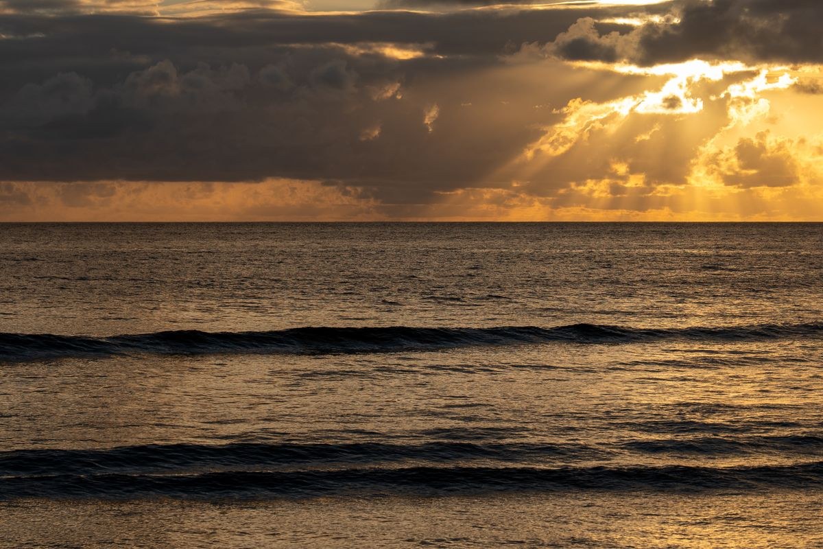 Sunset over the ocean with clouds in Fiji