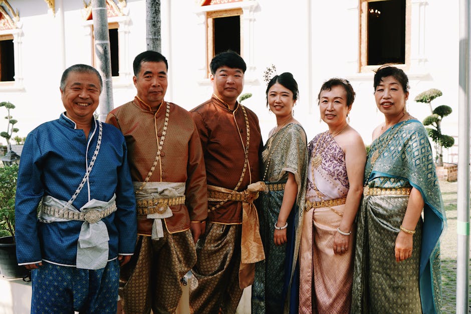 Family wearing traditional Thai attire posing at a temple in Chiang Mai