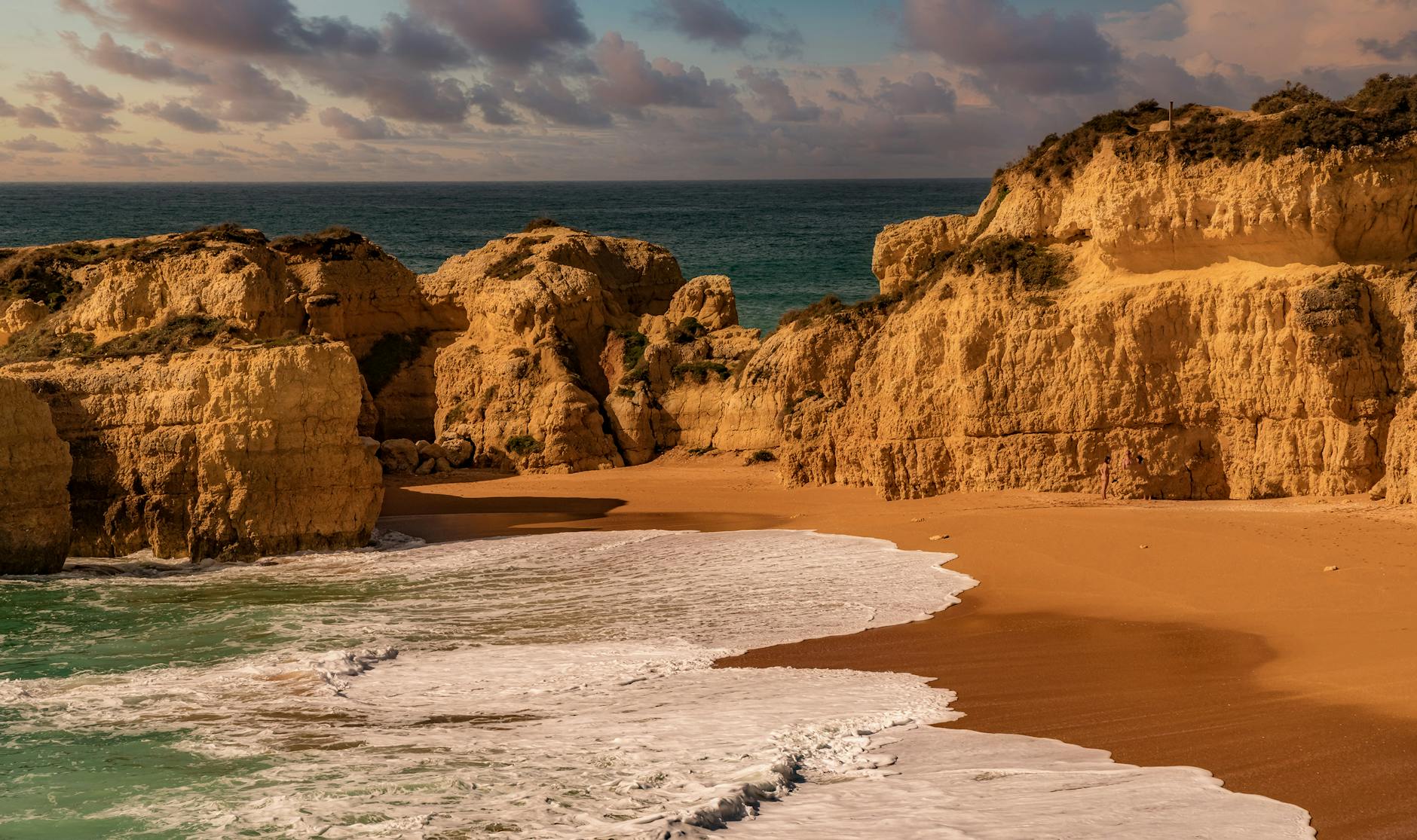 Golden cliffs and sandy beach on a sunny Canary Islands coastline