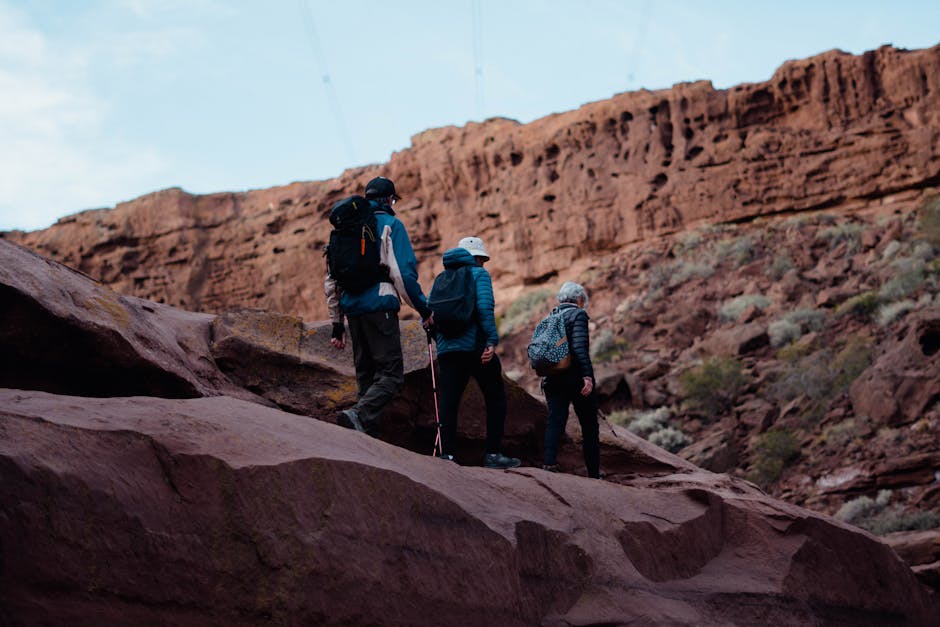 Hikers exploring red rock canyon terrain on a family hiking adventure