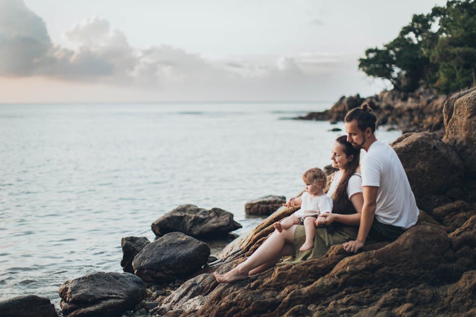 Family enjoying serene moment by the seaside at sunset - cruise vacation value