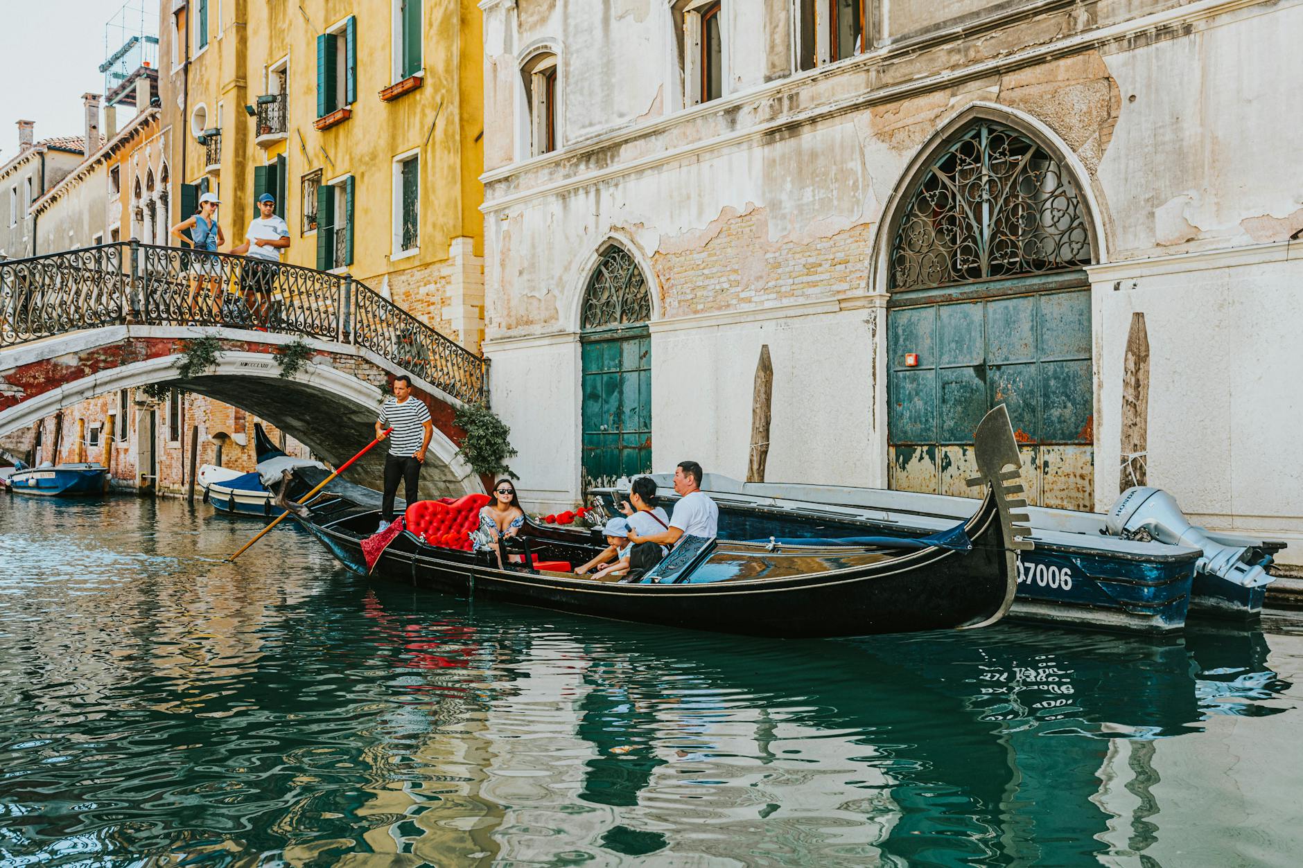 Gondola on a Venice canal under a historic bridge, an iconic moment on a 10-day Italy family itinerary