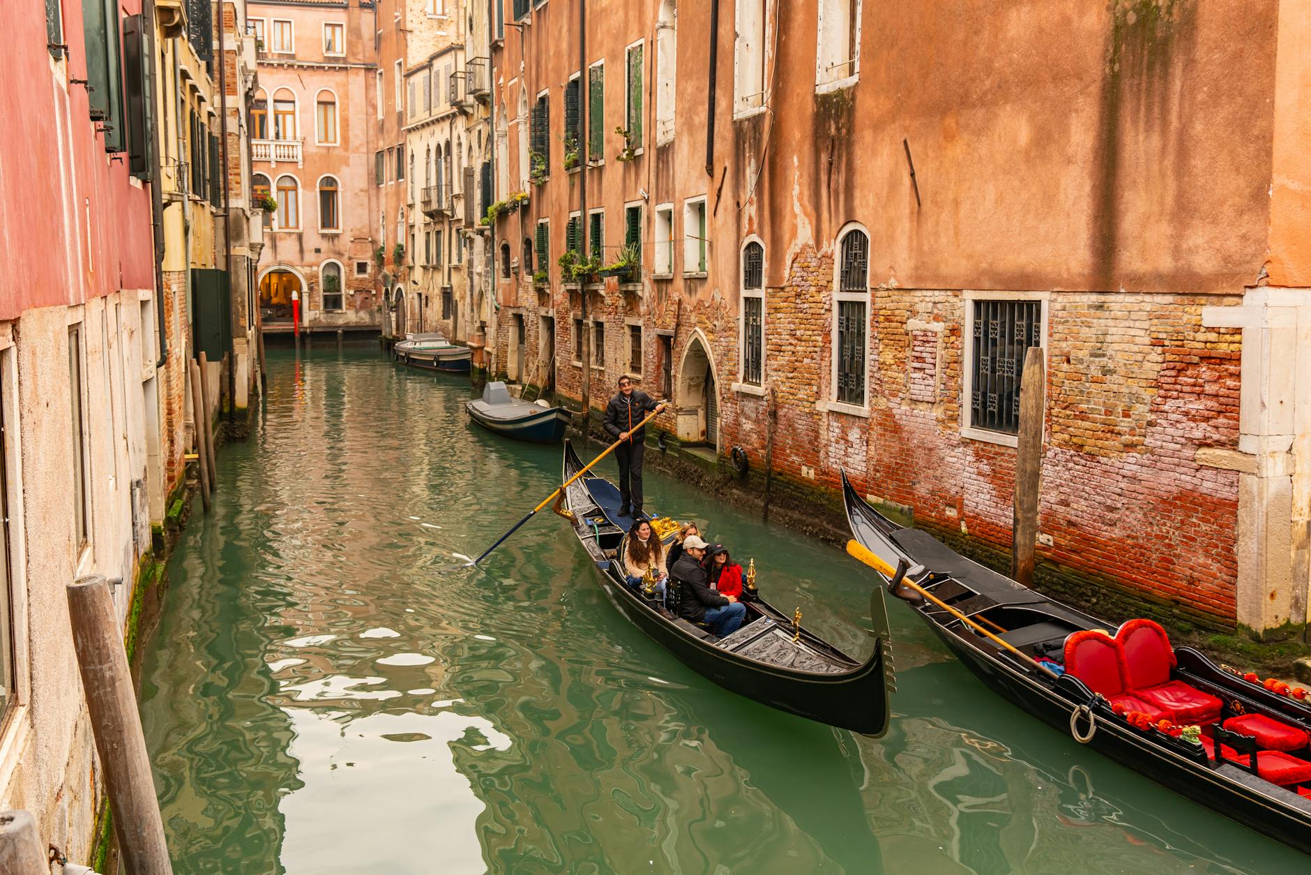 Gondolas on a charming canal surrounded by historic buildings in Venice Italy