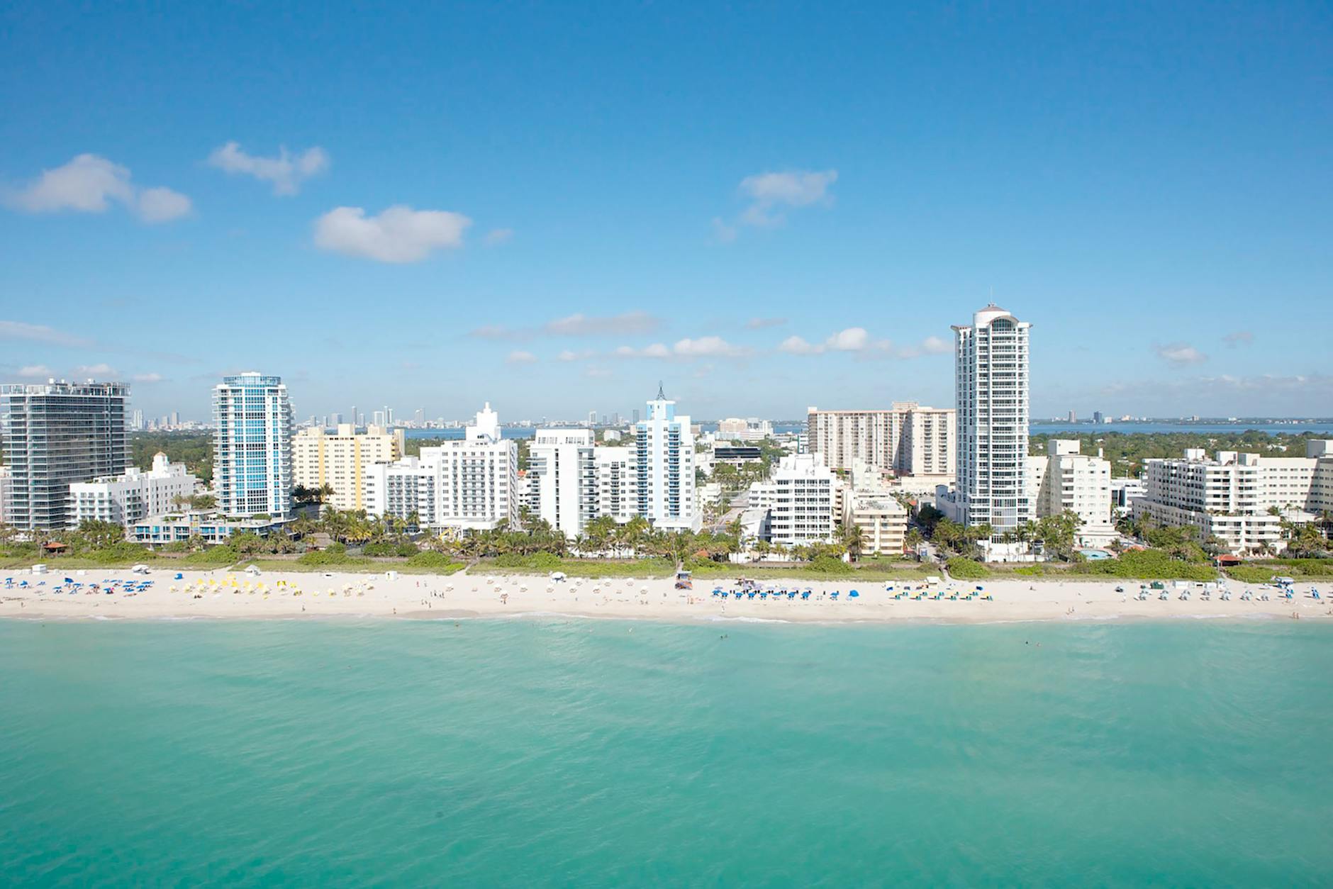 Miami Beach skyline with sandy coastline and turquoise ocean water from above