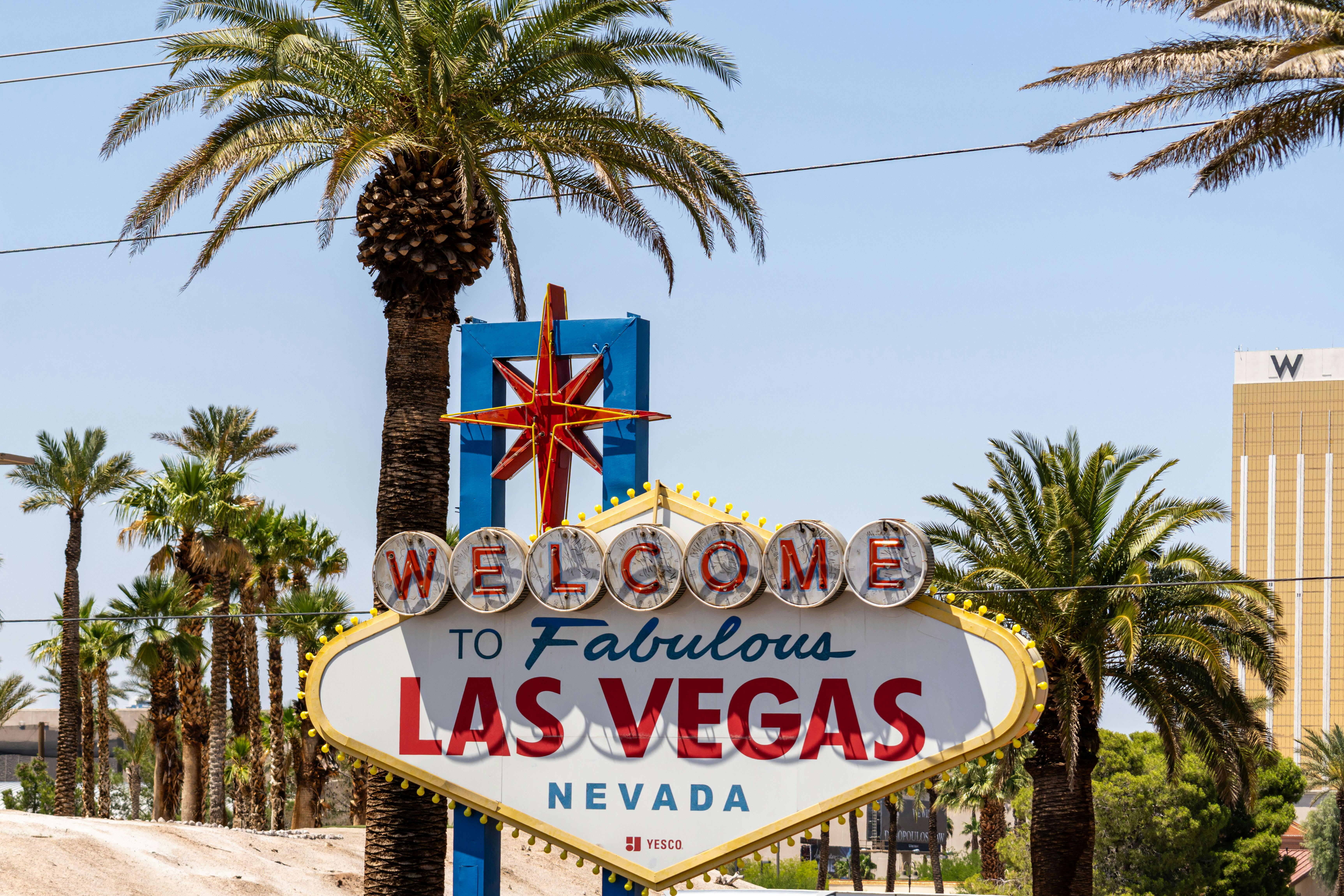 Iconic Welcome to Fabulous Las Vegas sign under daytime blue sky with palm trees &mdash; the family-friendly Vegas frame most parents don't consider