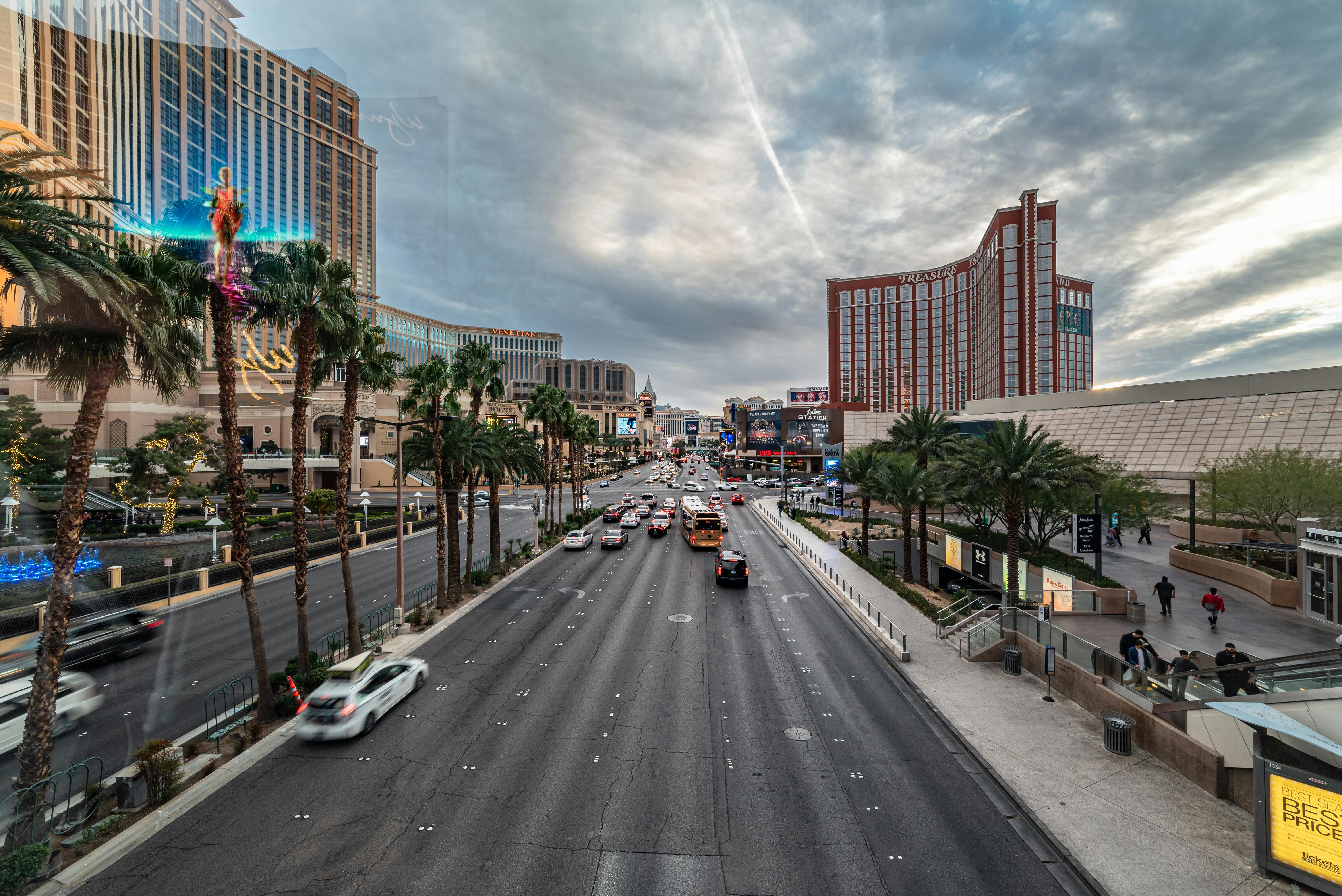 Las Vegas Strip with palm trees and daytime traffic showing the family-accessible side of Vegas beyond the casino-night reputation