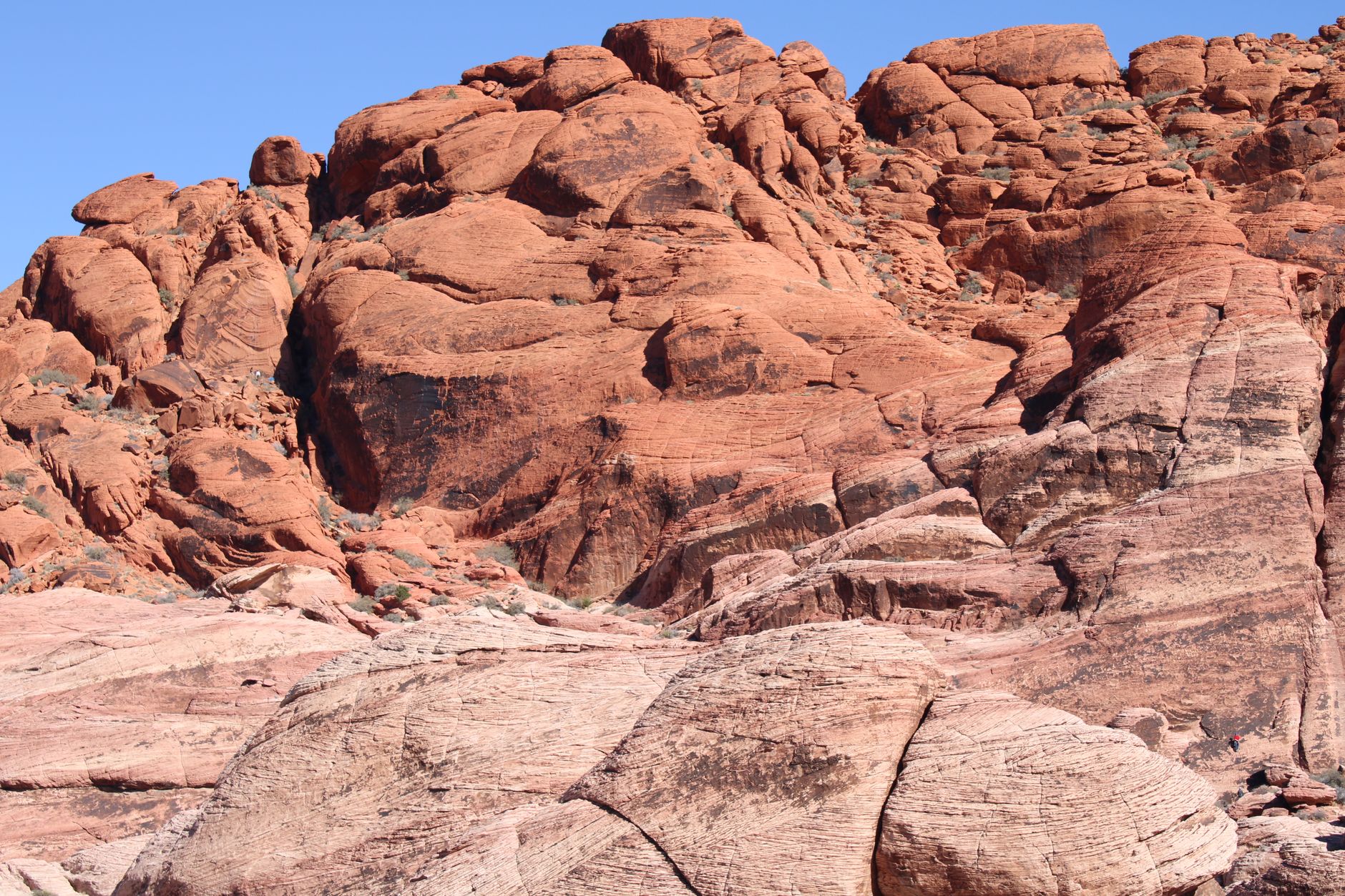 Family walking past red rock desert near Las Vegas &mdash; the cooler outdoor escape from the Strip's summer heat