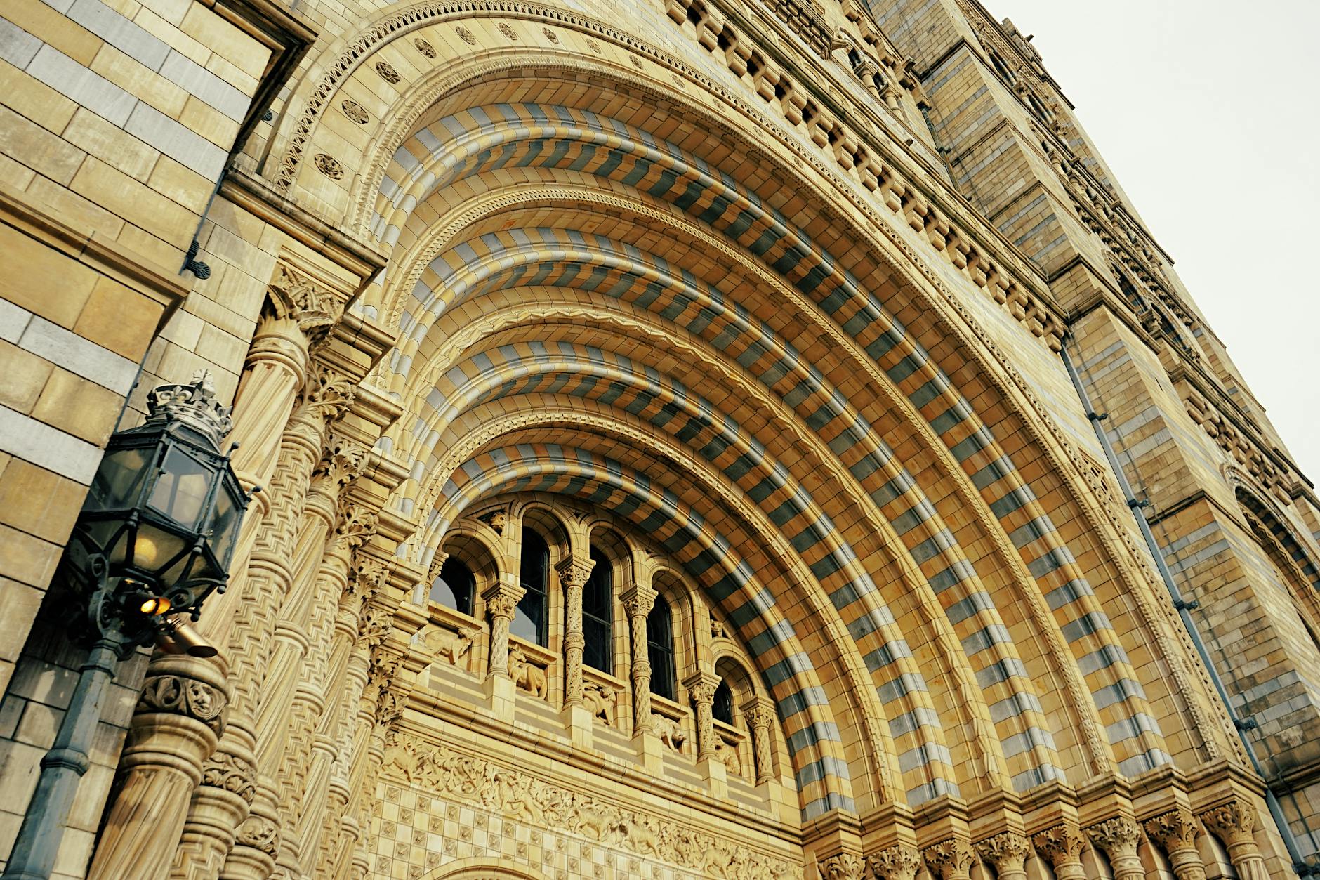 Natural History Museum exterior facade in London with ornate stonework and arched windows