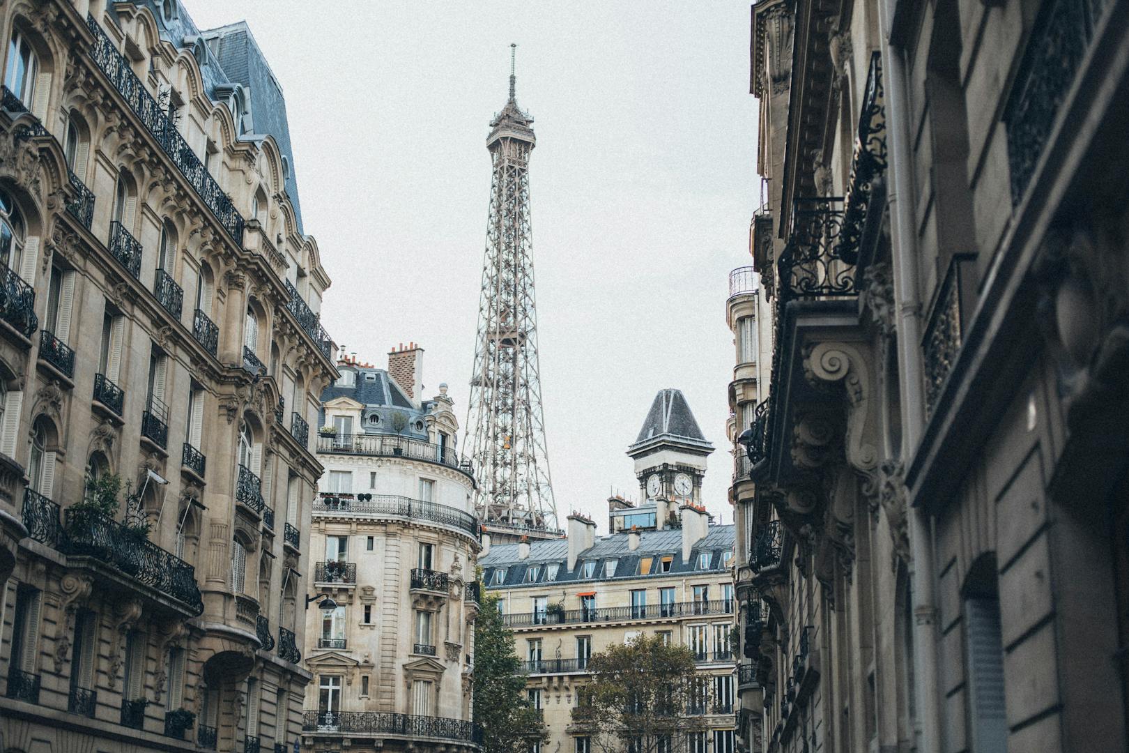 The Eiffel Tower rising above Paris rooftops and buildings